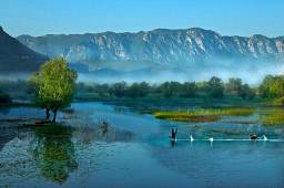 Вас вітає найбільше озеро на Балканах, що розташовується на території Чорногорії та Албанії. 2/3 озера належить Чорногорії. Площа Скадарського озера близько 390 км². Природна водойма не лише визначна своїми розмірами. Це одне з небагатьох місць у Європі, що є природнім ареалом життя пеліканів та великого гніздування птахів.